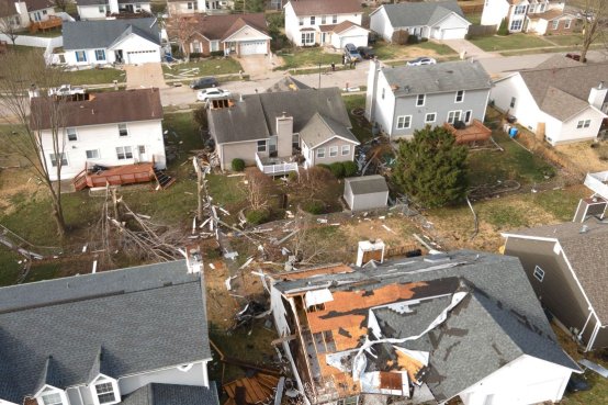 Debris lies around damaged houses the morning after a tornado touched down in Florissant, Missouri, on March 15, 2025.